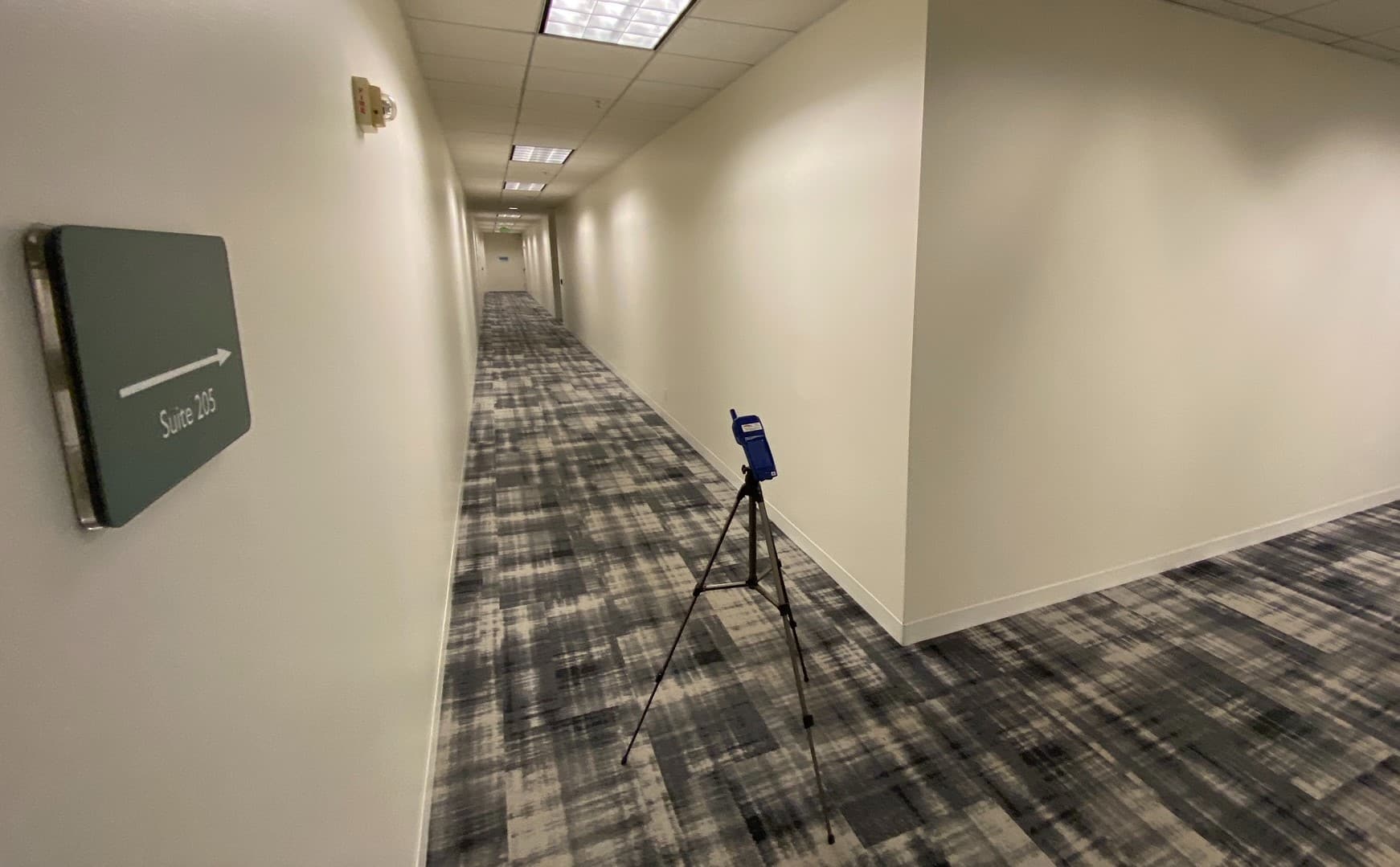 An indoor air quality monitor in the hallway of an office building An indoor air quality monitor in the hallway of an office building